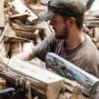 Man delivering and stacking firewood